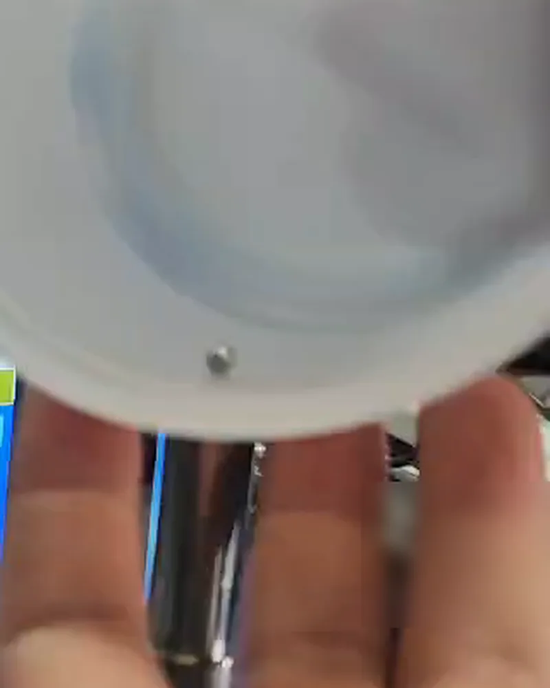 Plastic closure held over the probe tip with the steel ball inside