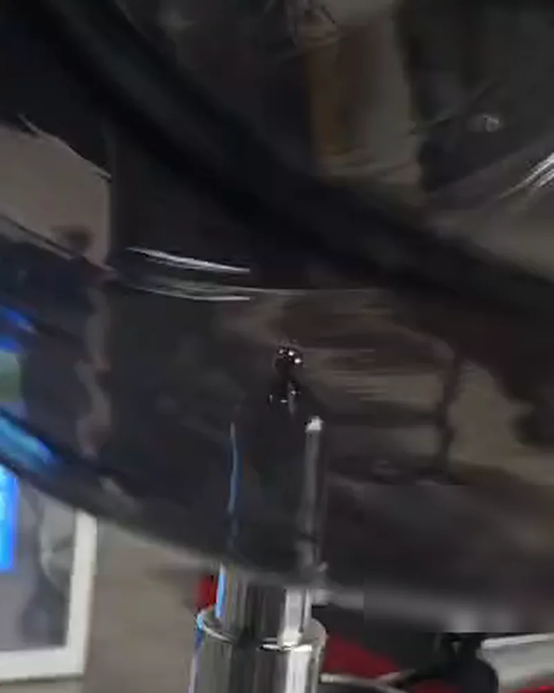 Wall of a large dark container resting on the probe tip with the ball inside